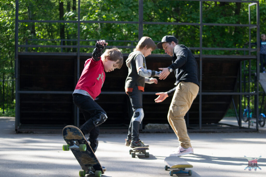 Adult skaters learning together in a group session with Vladimir