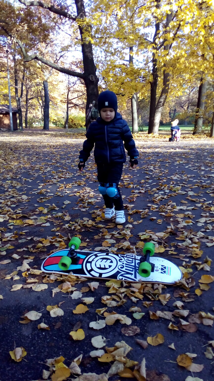 Young beginner taking first steps on a skateboard