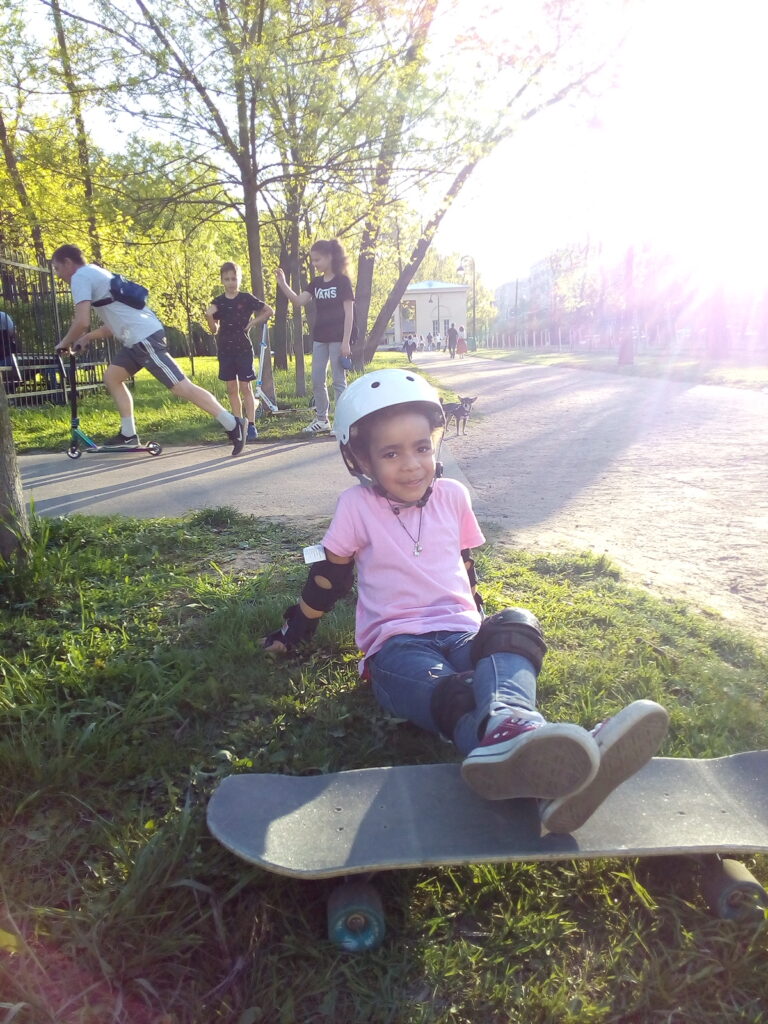 Young child learning to skateboard with One2Flip